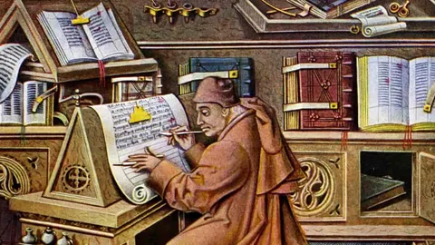 a 15th Century drawing of a medieval scribe at work in his scriptorium